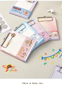 Macro shot of A6 clipboard memo pad with cute cartoon bears and metal binder clip detail