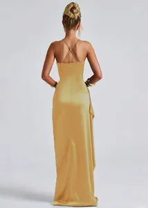 Elegant gold satin dress featuring cross back straps and open back detailing on floor-length hem