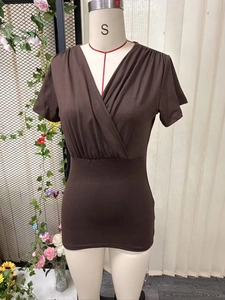 Detailed view of deep brown V-neck slim fit top with gathered waist texture