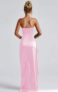 Detail view of the elegant pink satin dress featuring cross back straps and smooth texture