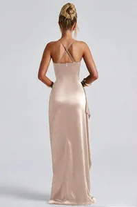 Macro view of champagne satin backless dress showing cross straps and silk texture