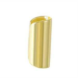 Macro view of polished golden stainless steel ear cuff with a smooth mirror finish