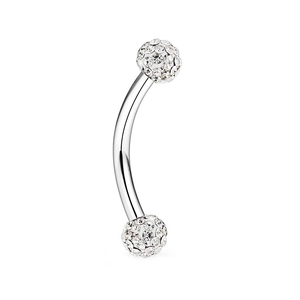 Macro shot of curved stainless steel eyebrow ring with dual shimmering crystal pave balls