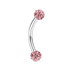 Close-up of curved stainless steel eyebrow ring with pink crystal encrusted Shamballa balls