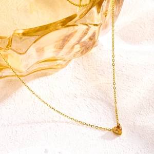 Golden heart pendant necklace with champagne birthstone on stainless steel chain