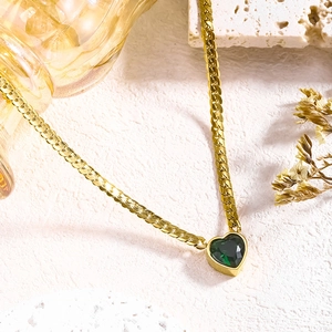 Elegant gold flat chain necklace featuring a deep green heart-shaped gemstone pendant