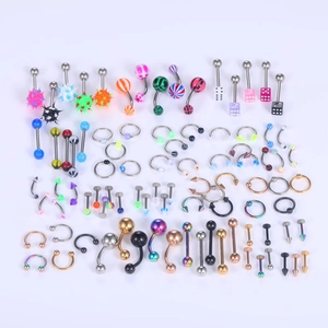 Flat lay of 120pcs assorted stainless steel body piercing kit with colorful jewelry parts