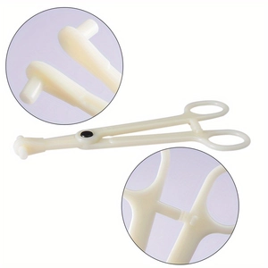Detail of disposable piercing clamp with locking mechanism and ivory plastic finish