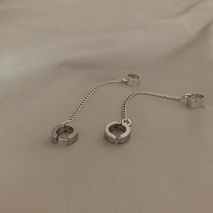 Detailed close-up of stainless steel chain earrings set with integrated ear cuff and stud