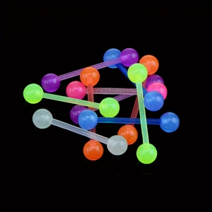 Macro shot of colorful acrylic tongue rings on a reflective black background