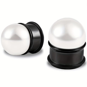 Detail of elegant white pearl ear plugs with minimalist black metallic base for gauges