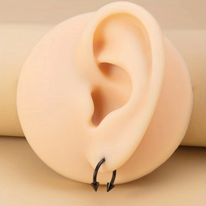 Black stainless steel horseshoe piercing with spikes shown on a skin-tone ear model