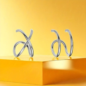 Set of four minimalist silver stainless steel nose rings and ear bone clips in a modern design