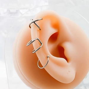 Set of 4 minimalist silver stainless steel ear cuffs shown on a realistic ear model