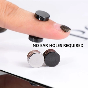 Detail of silver and black magnetic earrings showing clip-on design for non-pierced ears