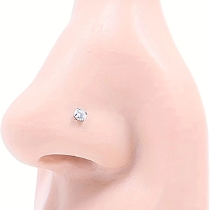 Polished stainless steel nose stud with round cubic zirconia on a model nose