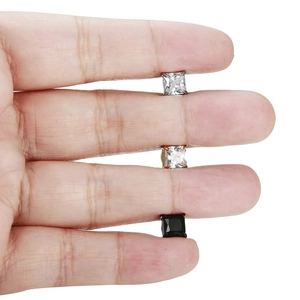 Detailed close-up of square zircon stud earrings set in silver gold and black plated steel