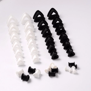 Set of black and white silicone triangle tunnel ear plugs and expanders for body piercing