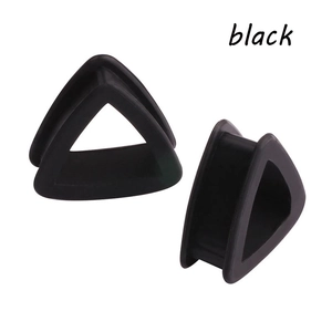 Detail view of double flared triangle silicone ear tunnels in matte black finish