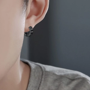 Men's minimalist black stainless steel hoop earrings on model with matte finish