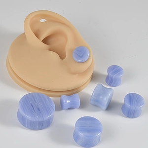 Macro shot of blue marble pattern stone ear plugs set showing natural texture and fit