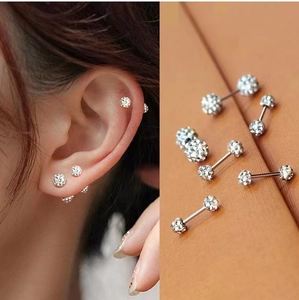 Close-up of sparkling full crystal ball barbell earrings for multi-position ear piercing