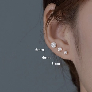 Detailed close-up of 3mm, 4mm, and 6mm stainless steel crystal stud earrings on the ear