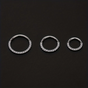 Three varying sizes of silver 316L stainless steel nose rings with cubic zirconia