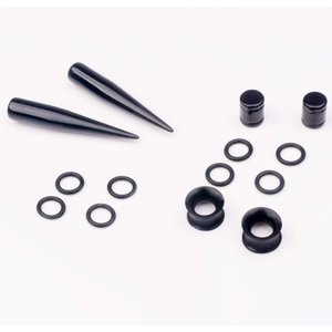 Close-up of black acrylic ear stretching set including tapers, plugs and rubber O-rings