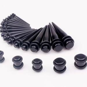 Detailed set of black acrylic ear tapers and plugs gauges in various sizes