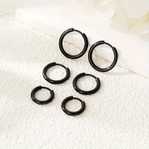 Set of three pairs of black stainless steel hoop earrings in various sizes with mirror finish