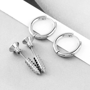 Close-up of silver stainless steel screw stud earrings and polished huggie hoops
