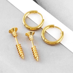 Detailed close-up of gold stainless steel huggie earrings and industrial screw stud set