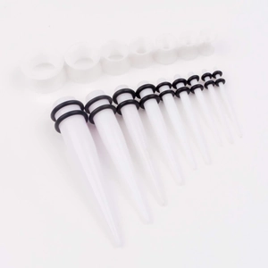 Detailed set of white acrylic ear tapers and tunnels with black rubber o-rings in various sizes