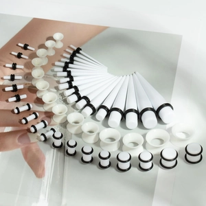 White acrylic ear stretching kit with tapers and tunnels in various sizes and O-rings