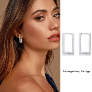 Detailed view of polished silver rectangle hoop earrings with classic snap closure