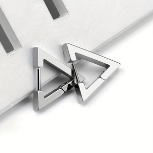 Macro shot of silver geometric triangle hoop earrings made of polished stainless steel