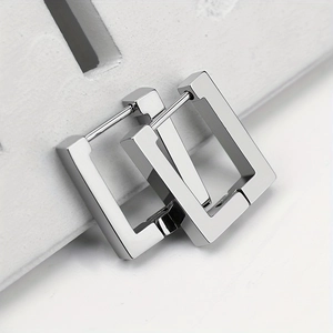Detailed macro view of polished silver rectangular geometric stainless steel hoop earrings