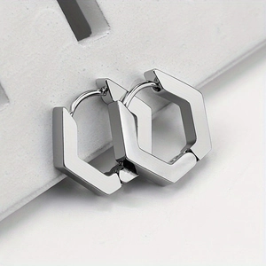 Macro shot of silver hexagonal stainless steel earrings with brushed and polished texture