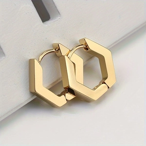 Detailed macro view of gold-plated hexagonal hoop earrings with secure hinged clasp