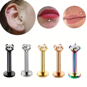Detail of 5-piece stainless steel labret stud set showing multiple colors and ear-lip wear