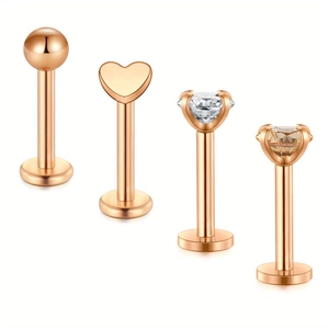 Detail view of 4-piece rose gold stainless steel piercing set with heart and zircon studs