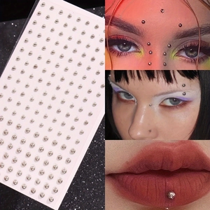 Detailed view of silver adhesive face studs for temporary lip and eyebrow piercing effect