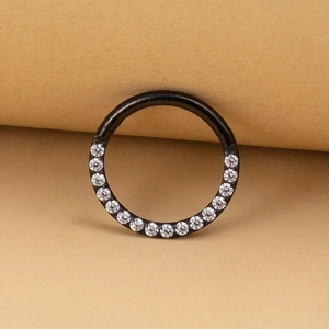Macro detail of black hinged segment ring featuring pavé-set white cubic zirconia