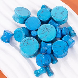 Blue turquoise stone ear gauges and plugs set with black marble texture in various sizes