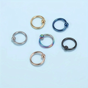 Top view of six stainless steel captive bead rings in various metallic finishes and colors