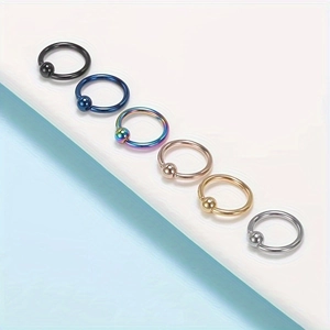 Detail view of captive bead rings in black, gold, and silver finishes for body piercing