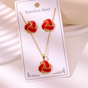 Detail view of 18k gold plated stainless steel red enamel knot necklace and earrings set