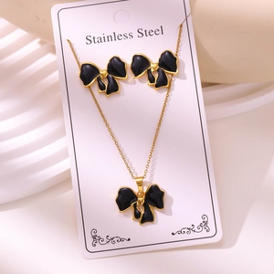 Golden stainless steel jewelry set with black enamel bow necklace and stud earrings