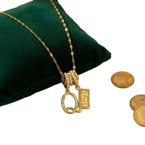 18k gold plated titanium necklace featuring crystal paved Q letter and 100 dollar bill pendant